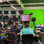 Production crew managing lighting and cameras during a live show at JDS Creative Academy.