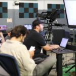 Students learning video production at JDS Creative Academy using professional cameras and editing software