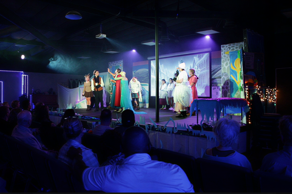 JDS Creative Academy students performing on stage during a community showcase and digital media production class