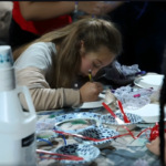 Students collaborating on a digital media project in a JDS Creative Academy classroom