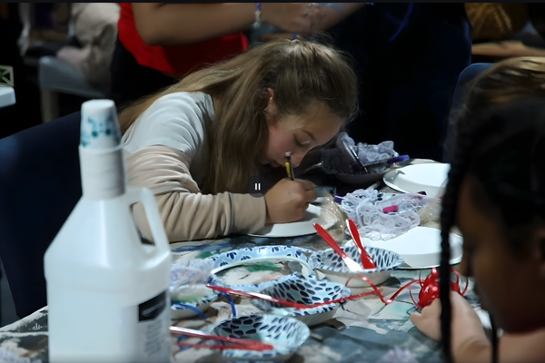 Students collaborating on a digital media project in a JDS Creative Academy classroom